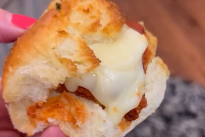 a person holding a Chicken Parmesan Slider