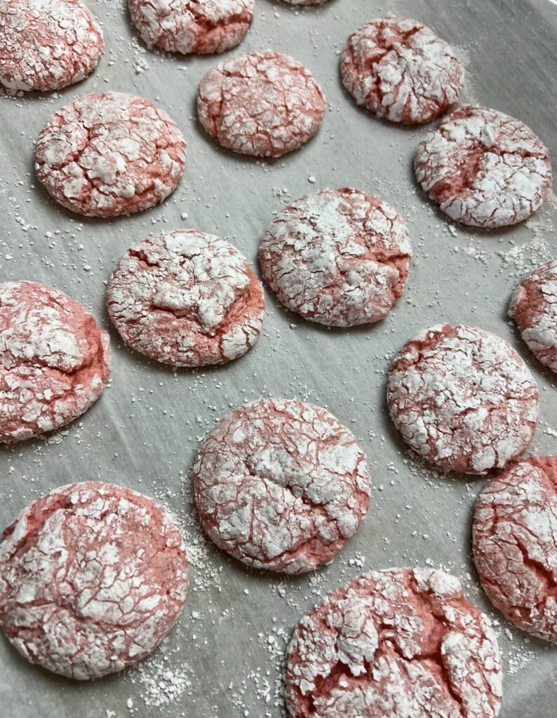 a group of Strawberry Cool Whip Cookies on a baking sheet